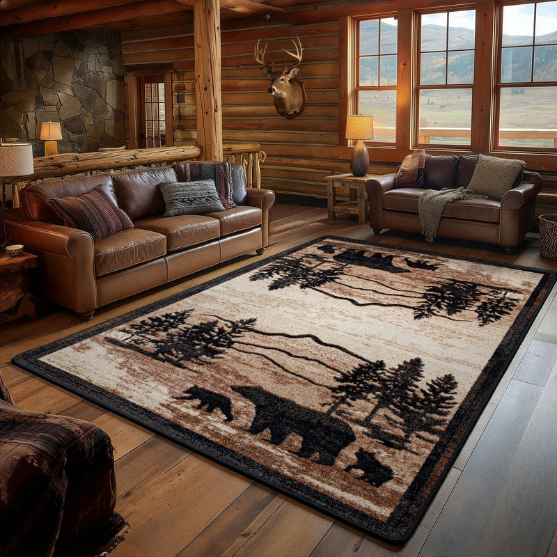 A large rectangular area rug with a rustic forest and bear design in beige, brown, and black, shown in a cozy log-cabin style living room with leather sofas and wood floors.