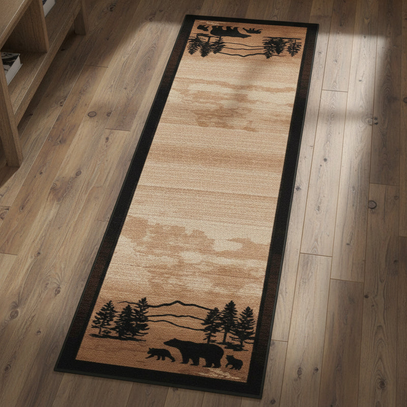 A long rectangular area rug with a natural wood grain texture in warm tan and brown tones, featuring black silhouetted forest and mountain motifs at the top and bottom.