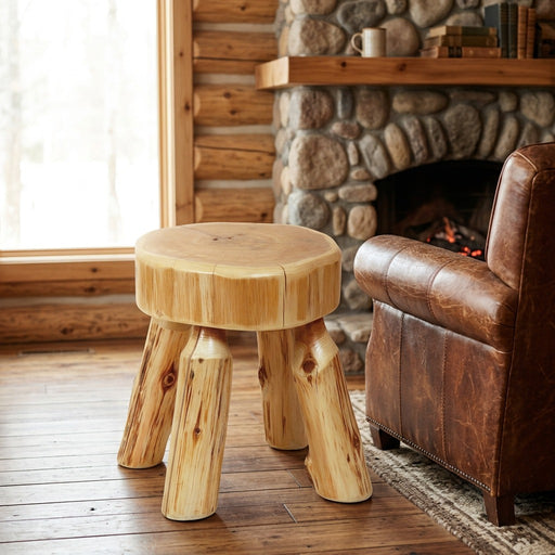 Bald Knob Cedar Log Foot Stool staged in a sunlit log cabin living room