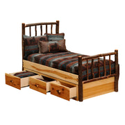 Angled view of the Bartlett Mountain Hickory Log Underbed Dresser with three drawers open beneath a hickory log bed