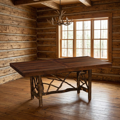 Bear Peak Barnwood and Hickory Twig Dining Table staged in a sunlit log cabin dining room