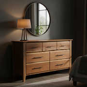 Beckwith Mountain Live Edge Walnut Seven Drawer Dresser under a round mirror in a bedroom