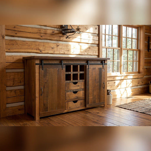 Bergen Peak Reclaimed Barnwood Sliding Door Sideboard staged in a sunlit log cabin dining room