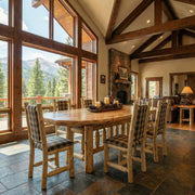 Bills Peak Cedar Log Oval Dining Table with chairs in a cabin dining room