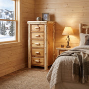 Blanca Peak Cedar Log Narrow Storage Chest in Natural beside a bed with a lamp near a snowy window