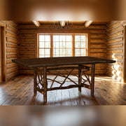 Boreas Mountain Hickory Log Twig Dining Table staged in a sunlit log cabin dining room