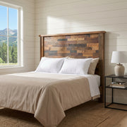 Castle Peak Barnwood Patchwork Headboard behind cream bedding in a white shiplap bedroom with a mountain view window