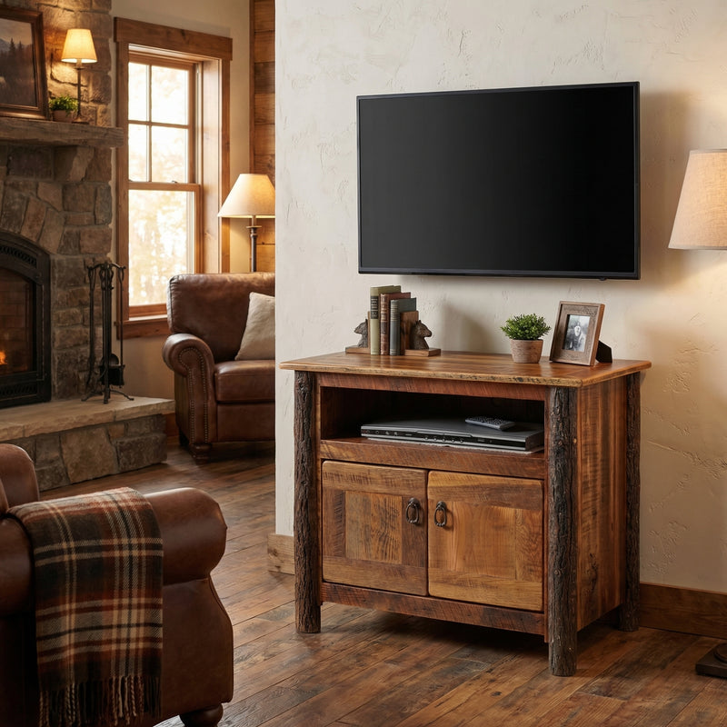 Cirrus Mountain Barnwood and Hickory TV Stand holding a TV in a cozy cabin room