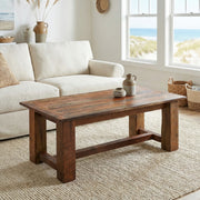 Clark Peak Reclaimed Barnwood Rectangle Coffee Table in front of a white sofa in a sunny living room