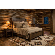 Conundrum Peak Pine Plank Bed staged in a cozy rustic log cabin bedroom