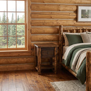 Cooper Peak Cedar Log Nightstand with Drawer and Shelf staged in a sunlit log cabin bedroom