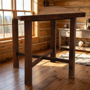 Cracktop Reclaimed Barnwood Square Pub Table staged in a sunlit log cabin dining room