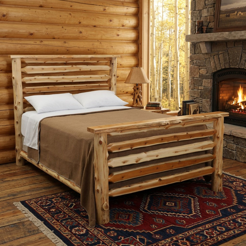 Crestone Peak Cedar Log Bed staged in a pine log lodge bedroom with stone fireplace, aspen window view, and wool rug