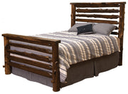 Angled view of the Crestone Peak Cedar Log Bed in Coffee stain with striped bedding