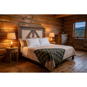 Cuerno Verde Pine Cottage Headboard staged against a log wall in a rustic cabin bedroom