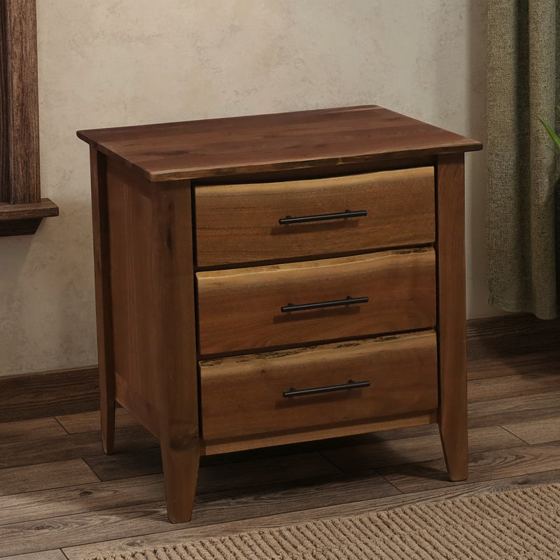 Cumberland Peak Live Edge Walnut Three Drawer Nightstand beside a bed in a cabin bedroom