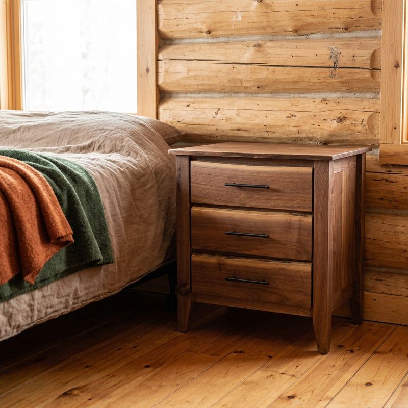 Cumberland Peak Live Edge Walnut Three Drawer Nightstand staged in a sunlit log cabin bedroom
