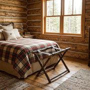 Emerald Peak Hickory Log Luggage Rack staged in a sunlit log cabin bedroom