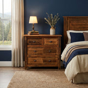 Engelmann Peak Barnwood and Hickory Low Boy Dresser with a lamp and vase beside a bed against a navy accent wall