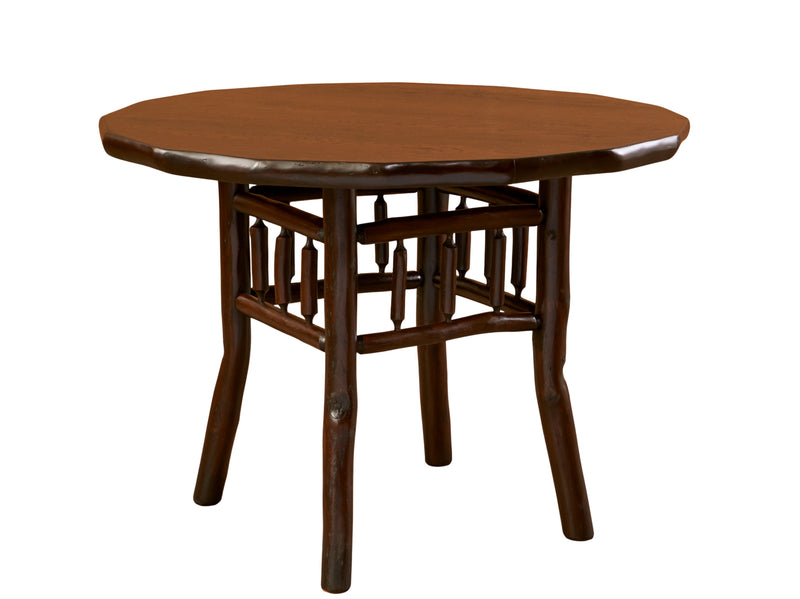 Angled view of the Engineer Mountain Hickory Log Round Dining Table in Natural showing bark-on trim