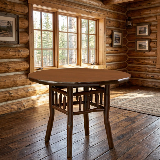 Engineer Mountain Hickory Log Round Dining Table staged in a sunlit log cabin dining room