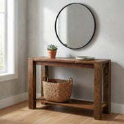 Fairchild Mountain Reclaimed Barnwood Post Sofa Table below a round mirror with a woven basket on the shelf