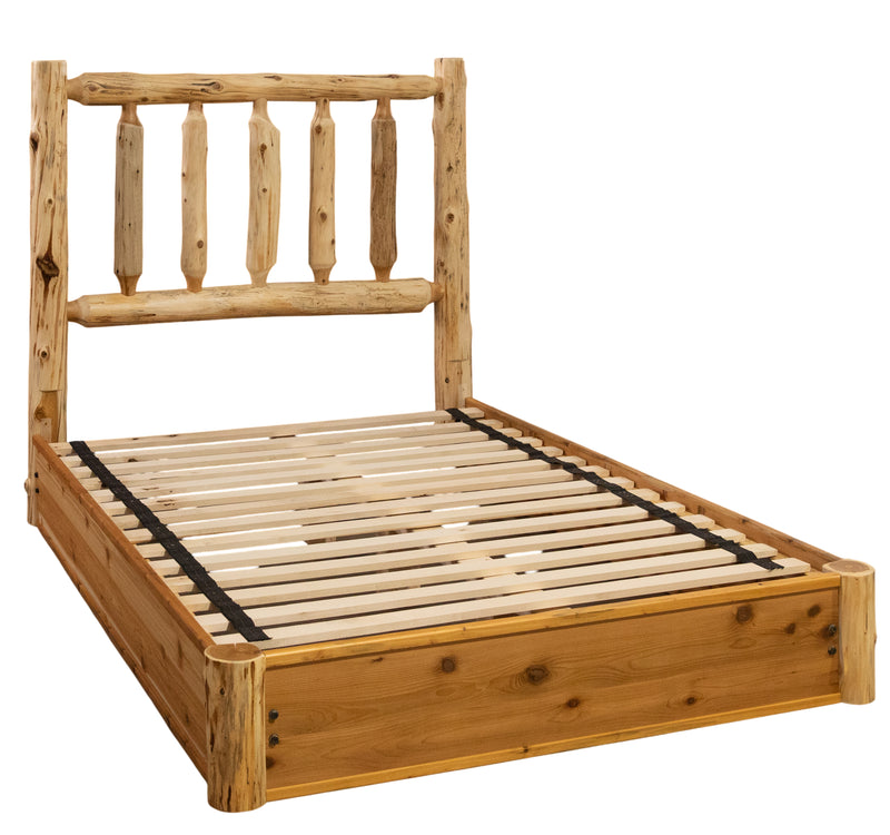 Angled view of the Grays Peak Cedar Log Platform Bed showing the spindle headboard and slatted platform base without mattress