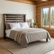 Grizzly Peak Cedar Live Edge Headboard in coffee stain in a log cabin bedroom with a pine forest window view
