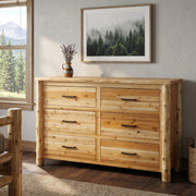 Hagerman Peak Cedar Log Dresser in a natural finish beneath a framed pine forest print in a cabin bedroom