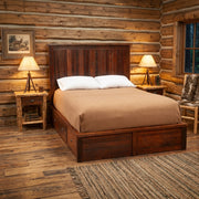 Hoosier Ridge Reclaimed Barnwood Underbed Dresser staged beneath a barnwood bed with twin lamps in a log cabin bedroom