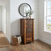 Kelso Mountain Reclaimed Barnwood Lingerie Chest below a round mirror in a white shiplap hallway with a woven basket