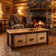 Lone Cone Hickory Log Three Drawer Coffee Table staged before a stone fireplace in a log cabin living room