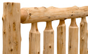 Close-up view of the Longs Peak Cedar Log Bed showing hand-peeled cedar spindles and natural grain
