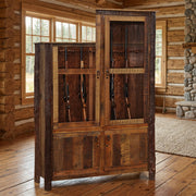 Mahana Peak Barnwood and Hickory Twelve Gun Cabinet staged in a sunlit log cabin living room