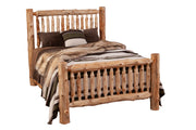 Angled view of the Maroon Bells Cedar Log Spindle Bed styled with striped wool bedding and fur throw
