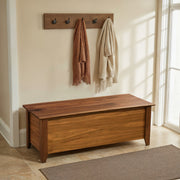 Matchless Mountain Live Edge Walnut Blanket Chest under a row of coat hooks in a bright room