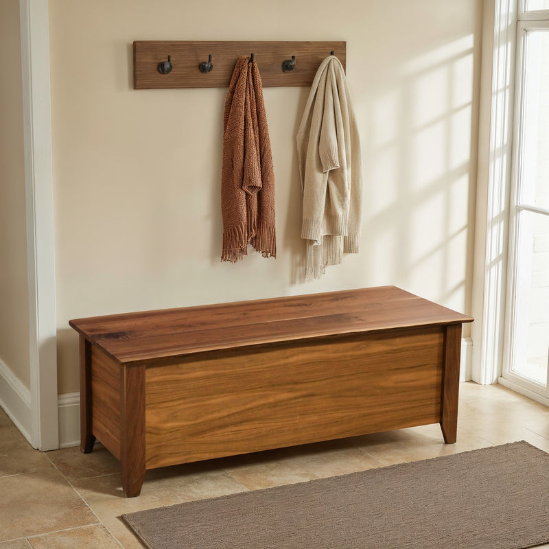 Matchless Mountain Live Edge Walnut Blanket Chest under a row of coat hooks in a bright room