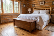 Matchless Mountain Live Edge Walnut Blanket Chest staged in a sunlit log cabin bedroom