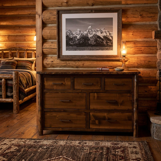 Mount Arkansas Cedar Log Dresser below a framed mountain photo in a lamp-lit log cabin bedroom