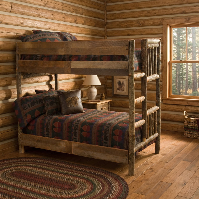 Mount Bross Barnwood and Hickory Bunk Bed with dark plaid bedding in a log-walled cabin bedroom with a braided rug