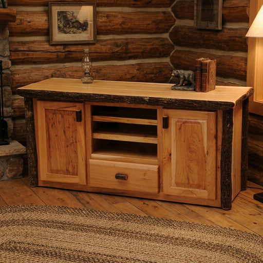Mount Cumulus Hickory Log Entertainment Center on a braided rug in a log cabin living room