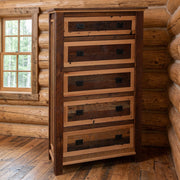 Mount Daly Reclaimed Barnwood Five Drawer Chest staged in a sunlit log cabin bedroom