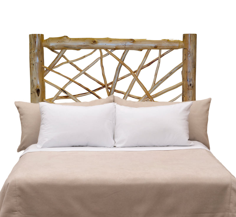 Front view of the Mount Democrat Cedar Log Twig Headboard styled with white pillows and tan bedding