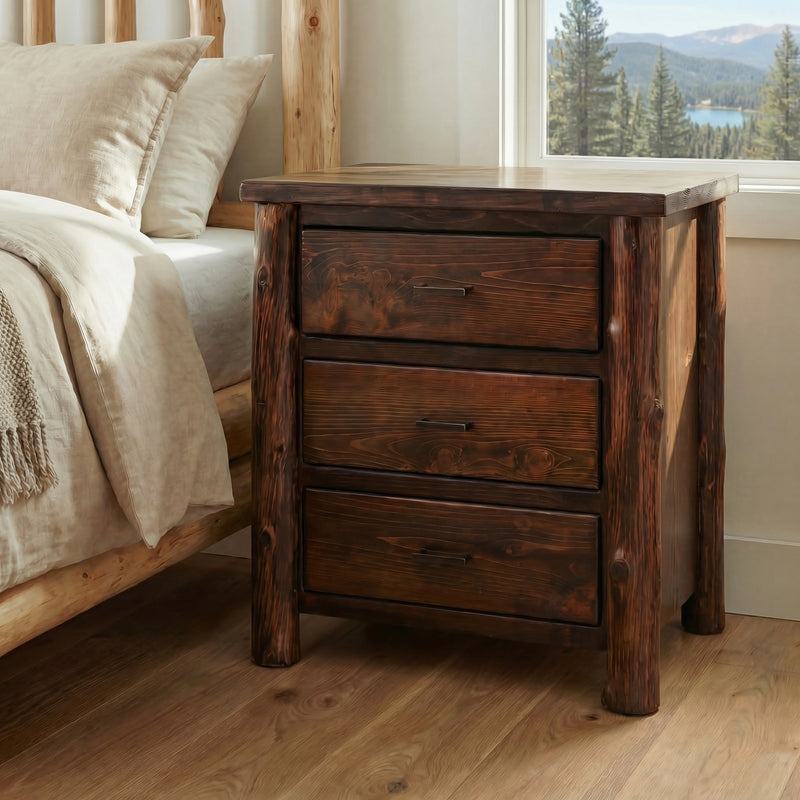Mount Dickinson Cedar Log Three Drawer Nightstand beside a bed in a rustic cabin bedroom