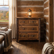 Mount Eva Barnwood and Hickory Chest of Drawers with a lantern on top beside a window in a log-walled cabin bedroom