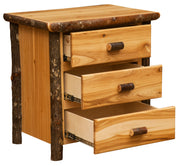Angled view of the Mount Flora Hickory Log Three Drawer Nightstand in Natural with all three drawers open