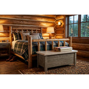 Mount Goliath Pine Blanket Chest staged at the foot of a bed in a rustic log cabin bedroom