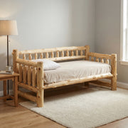 Mount Guyot Cedar Log Daybed with white bedding beside a window and floor lamp in a bright bedroom