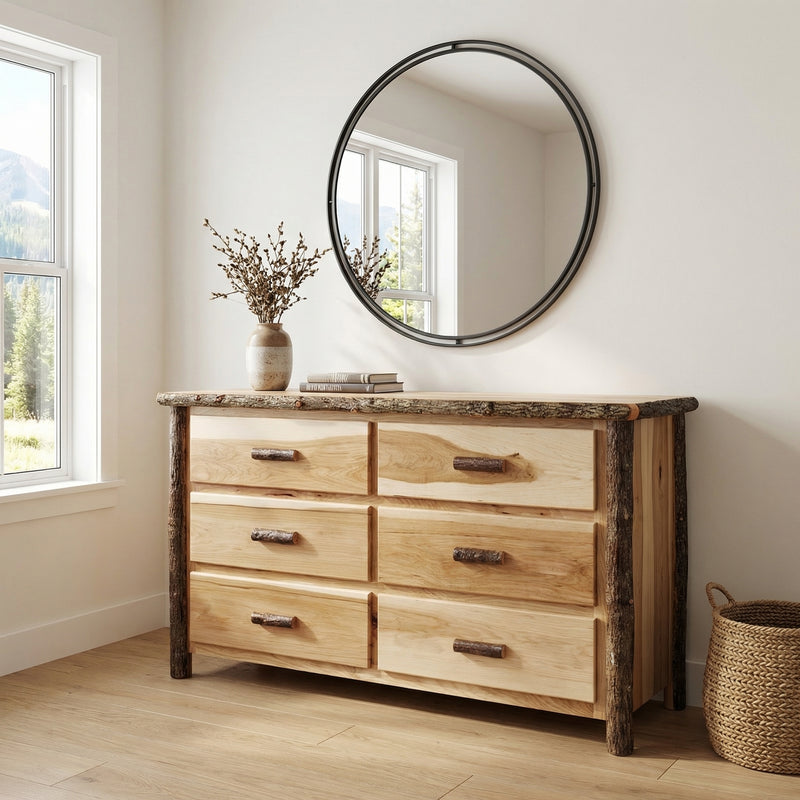 Mount Jackson Hickory Log Dresser in Natural below a round mirror with a vase of dried stems in a white bedroom
