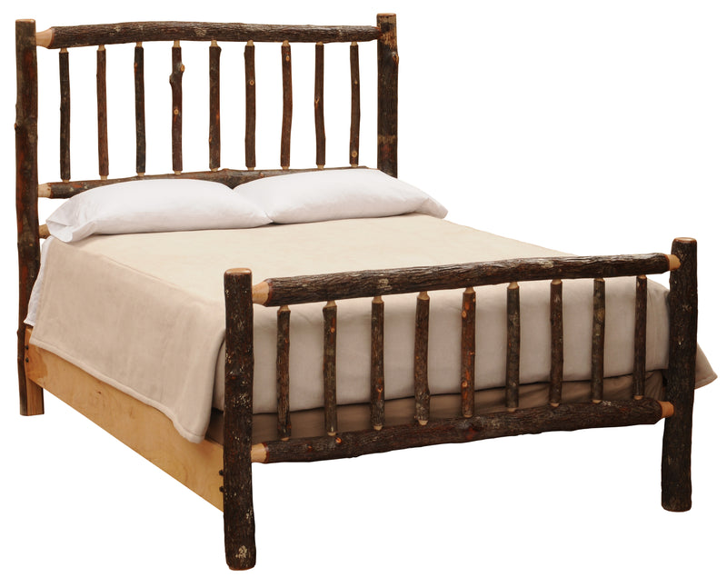 Angled view of the Mount Lincoln Hickory Log Bed with cream bedding showing bark-on hickory spindles and natural side rails